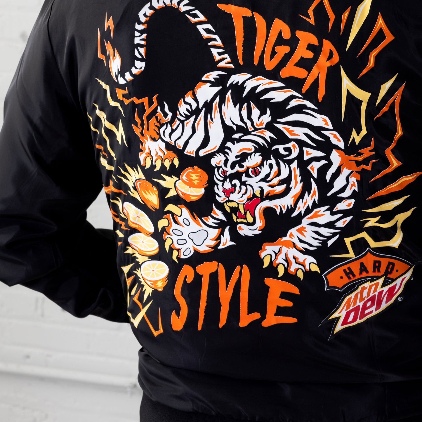 Close up of large back Tiger Style graphic of Hard Mountain Dew LIVEWIRE logo woven bomber jacket.