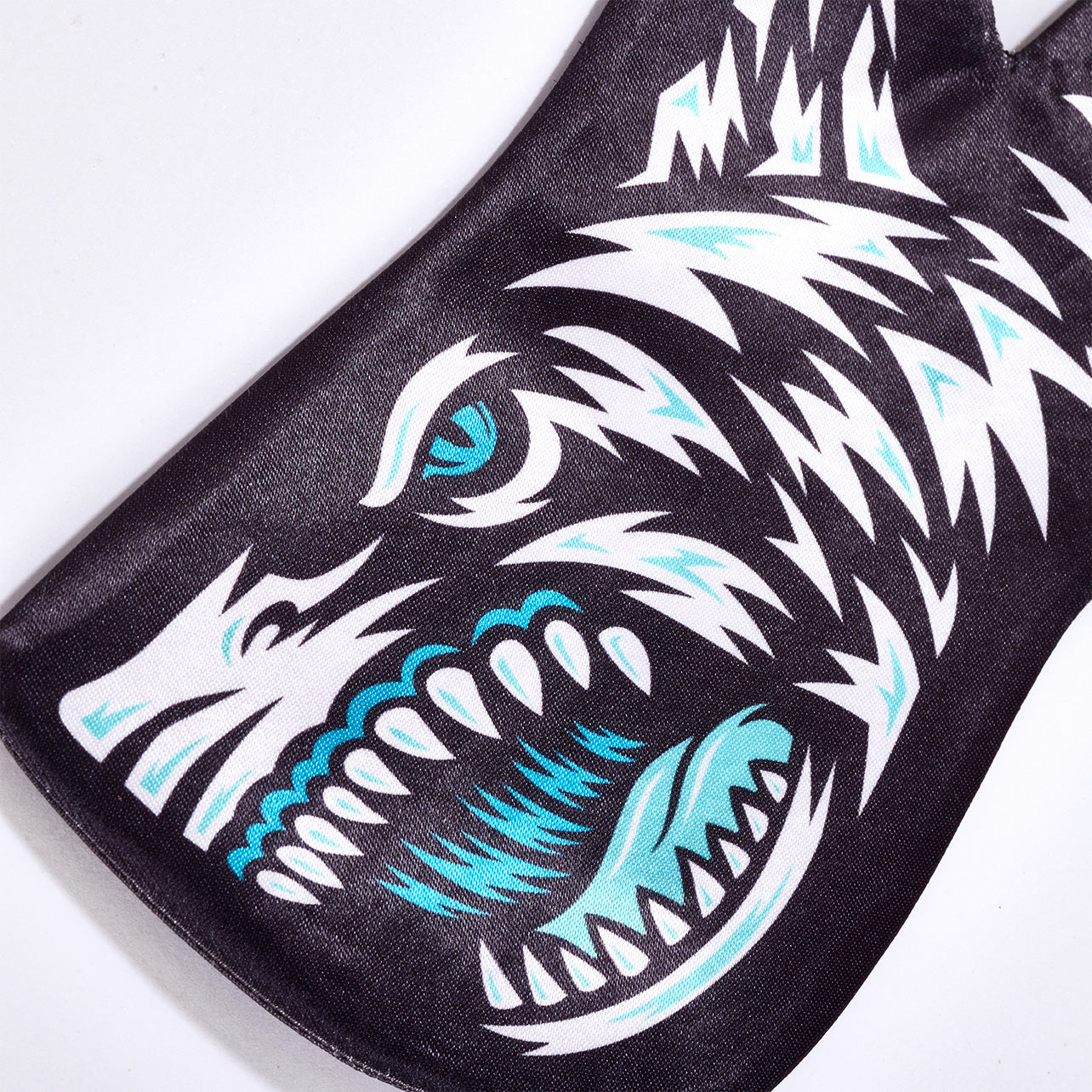 Close-up of the Hard Mountain Dew Baja Blast tie’s shark design, showing detailed colors: white, black, teal, and light teal, with visible dorsal and pectoral fins.