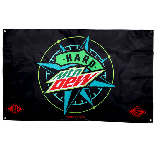 Black rectangular flag for "Hard MTN DEW." The center features the "MTN DEW" logo in green and red with "HARD" written in green above it. This is set against a teal starburst or compass-like design with a thin neon green circle around it. In the bottom left corner, there's a red diamond shape with "21+" in white. In the bottom right corner, there's a red diamond shape with "5% ALC/VOL" in white. Below the main design, small white text reads "CONTAINS ALCOHOL." There are metal grommets in each corner.