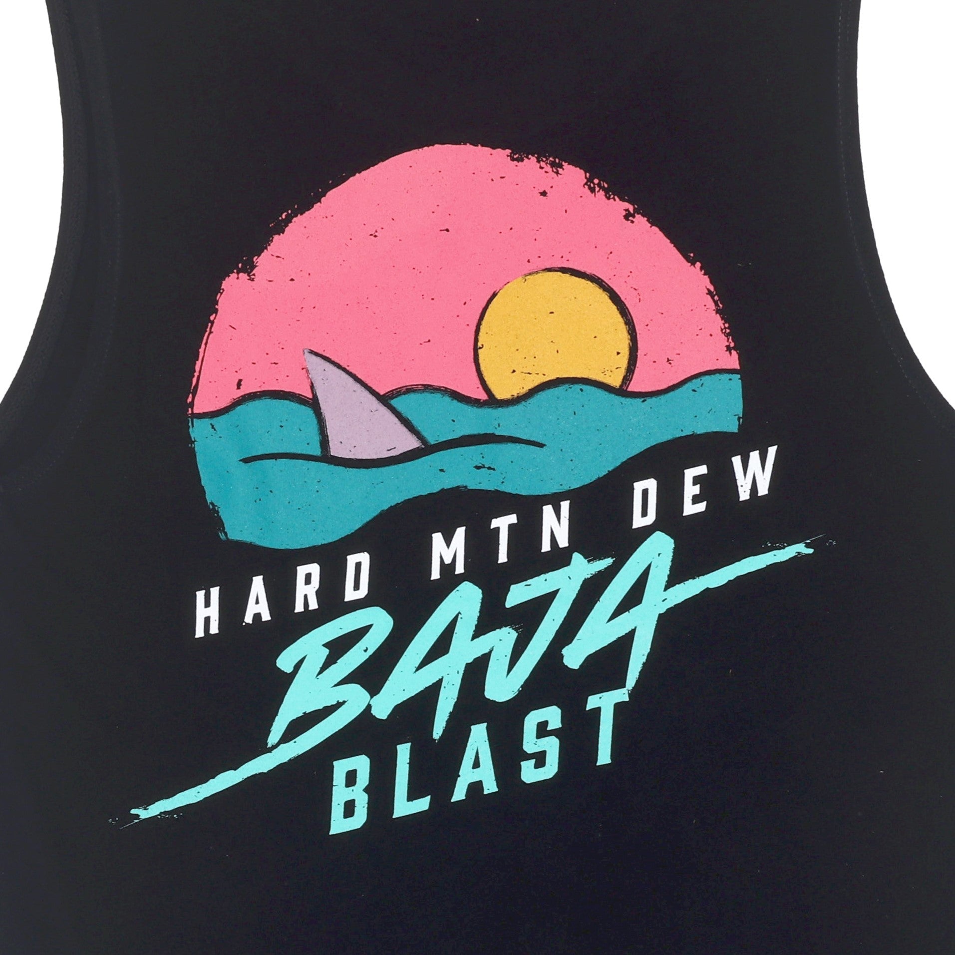 Close-up of the artwork on the back of a black muscle tank. The design features a retro 90s graphic with a shark fin emerging from teal waves, a pink sunset, and an orange sun in a circular shape. The Hard Mountain Dew Baja Blast text is included in the same retro style.