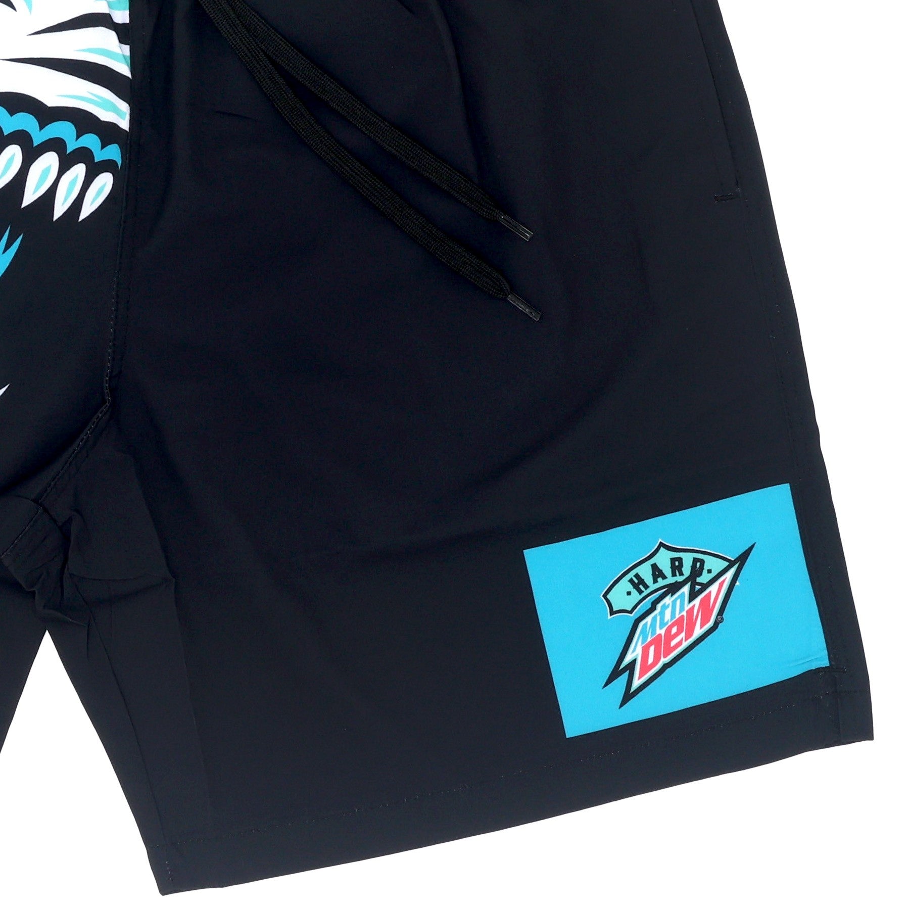 Close-up of the front bottom left leg of the men's Hard Mountain Dew Baja Blast swim trunks, showing the teal square logo with the Baja Blast design.