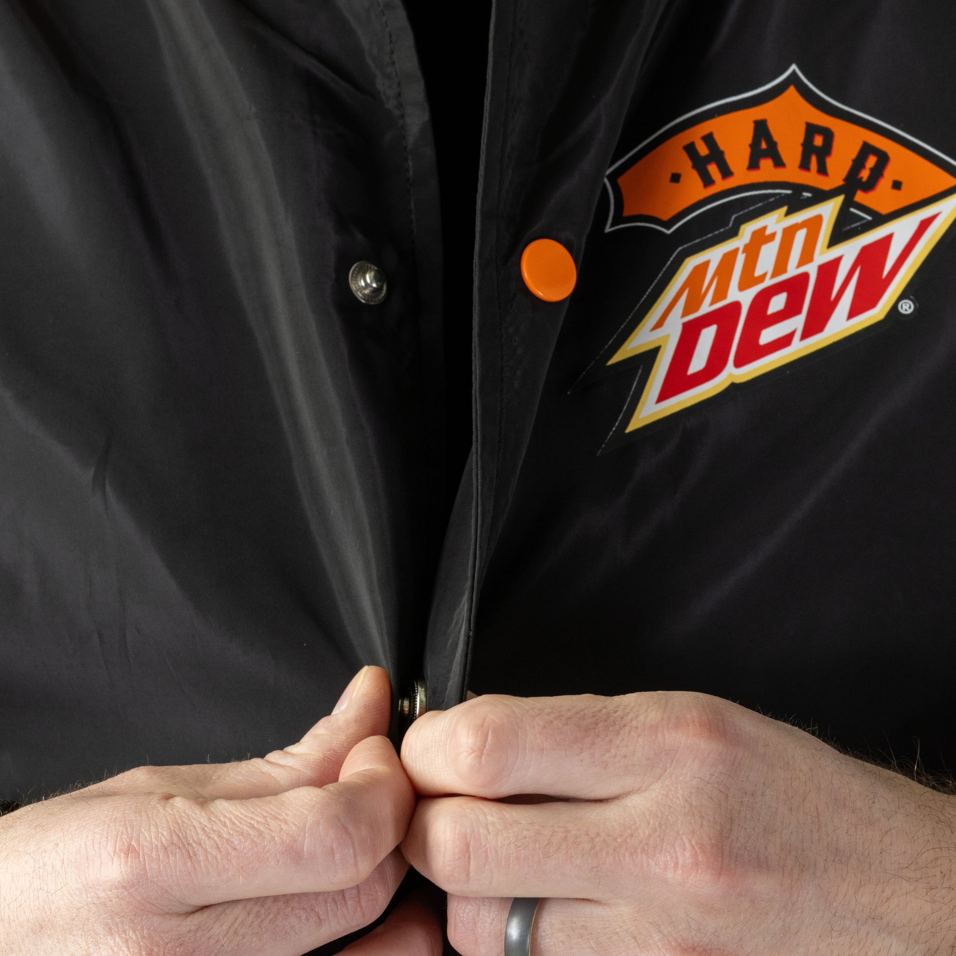 Close up of Hard Mountain Dew LIVEWIRE logo and orange snap detail. 