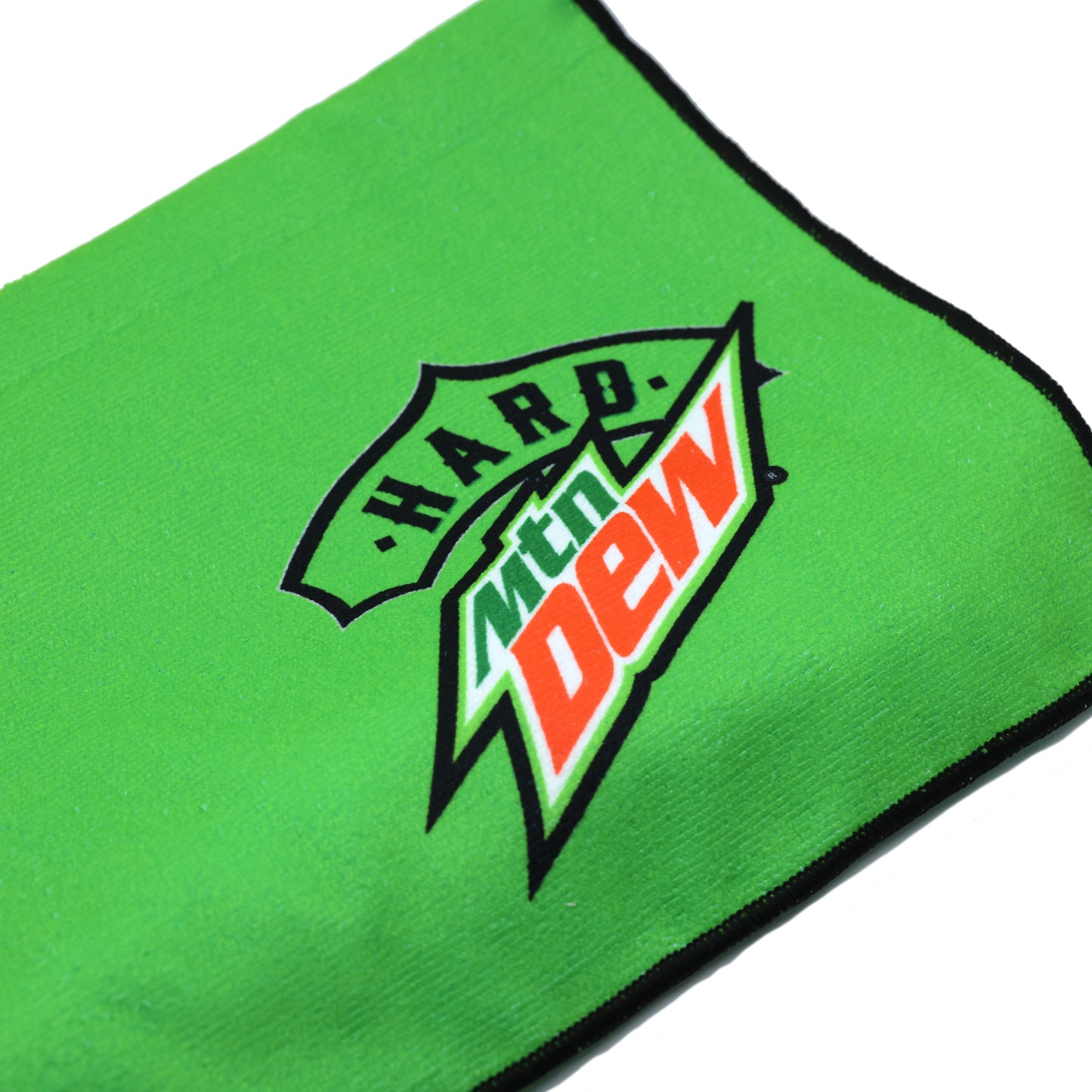Close-up of a folded Hard Mountain Dew towel showing the logo prominently. The towel’s design includes bold colors and branding details.