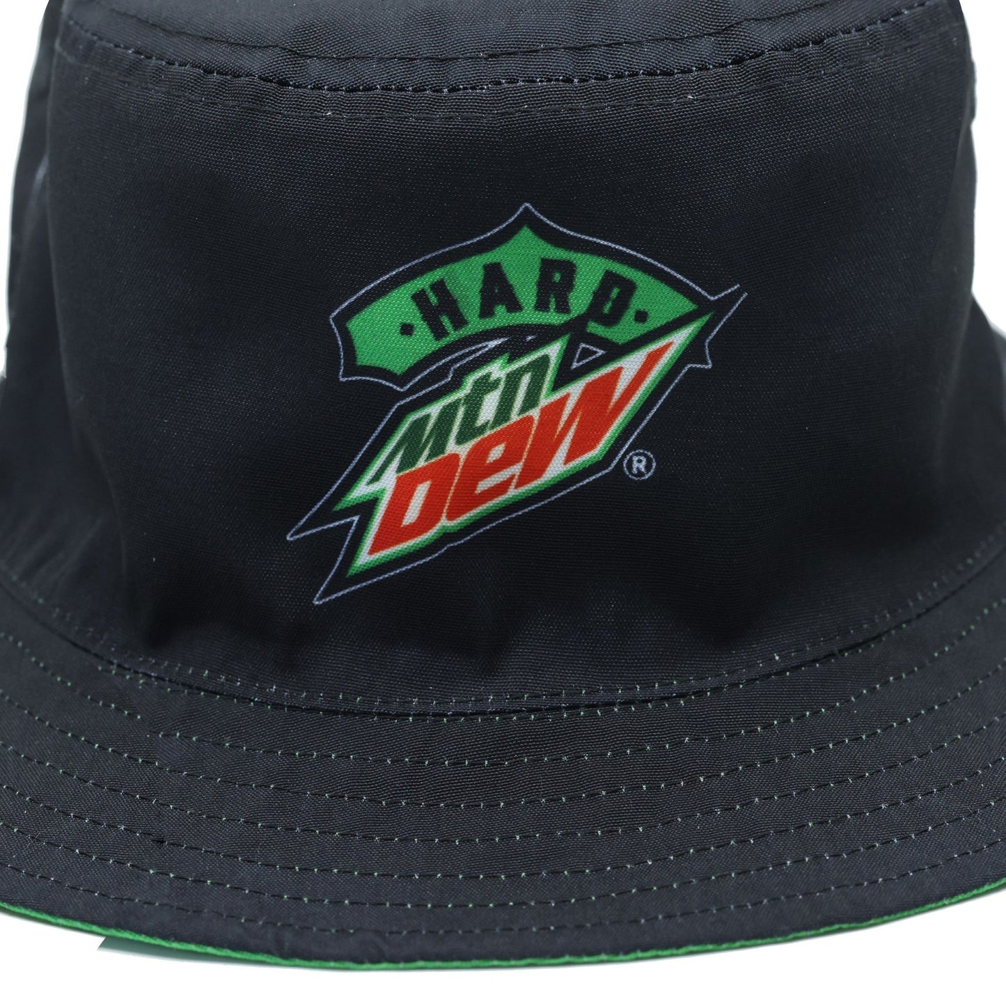 Close-up of the Hard Mountain Dew logo on the solid black side of the bucket hat. The logo is prominently displayed against the black background.