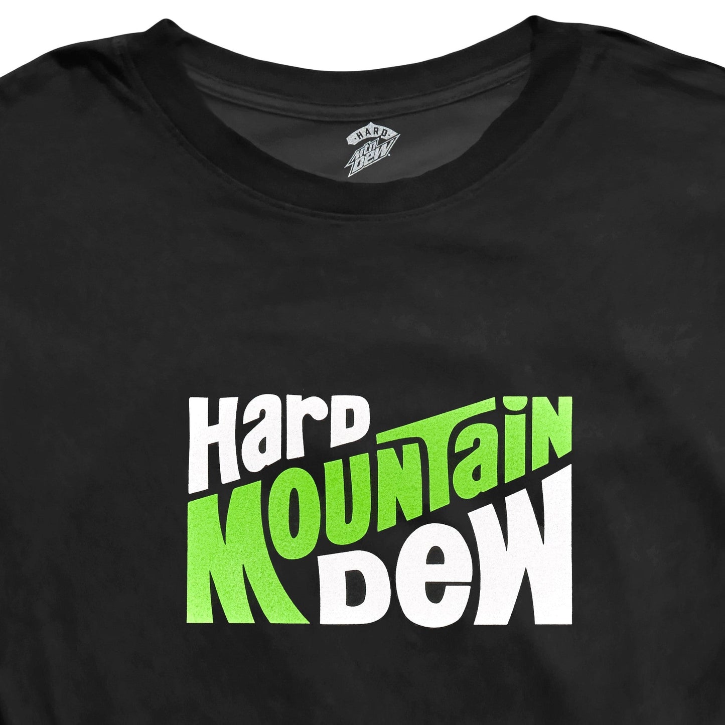 Close-up of the front design on a black Hard Mountain Dew t-shirt, featuring retro-style text of the brand. The design is prominently displayed against the shirt's fabric.