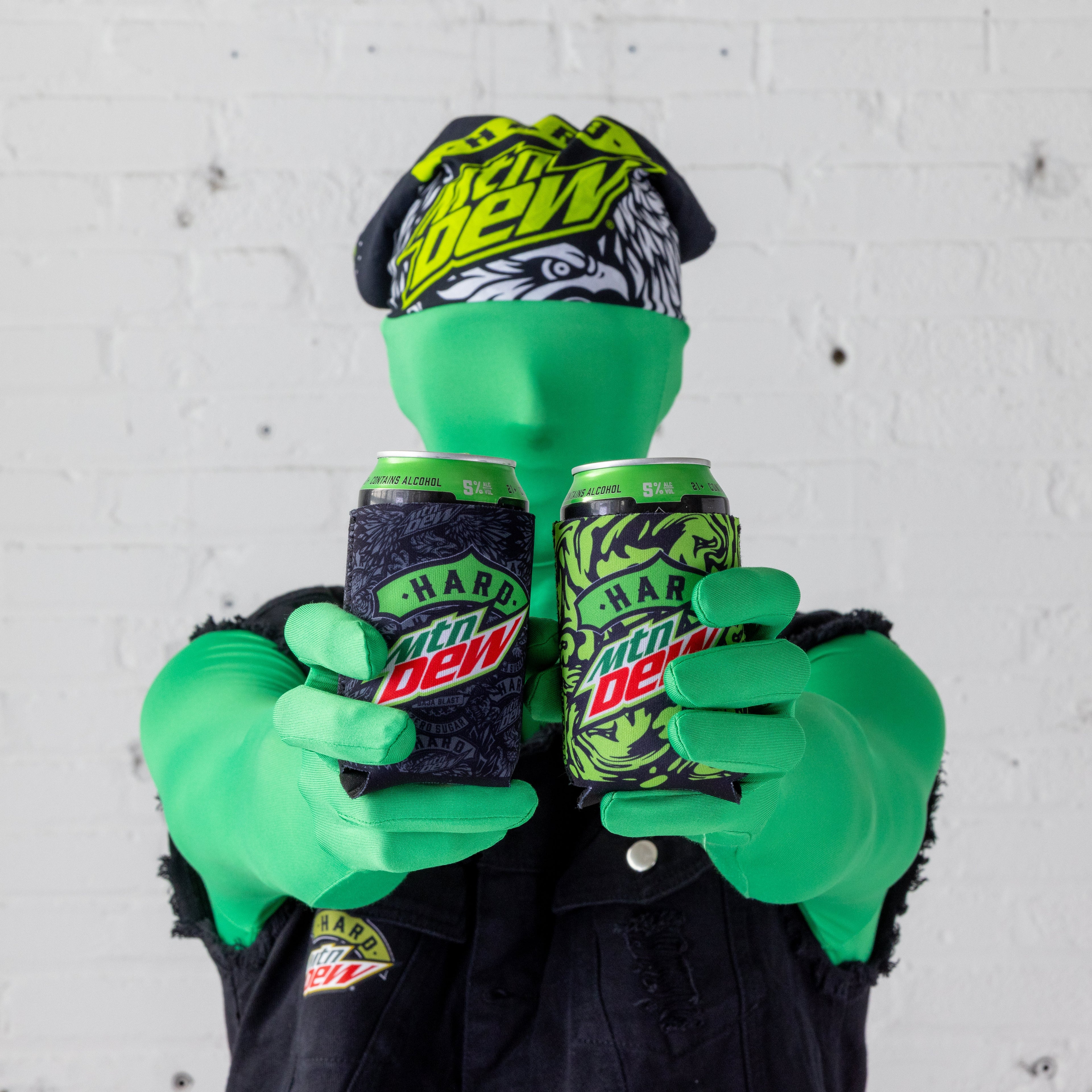 Model wearing a Hard Mountain Dew bandanna in black, white, and neon green. The bandanna features the Hard Mountain Dew logo and an eagle illustration, with the bold colors and graphics clearly visible.